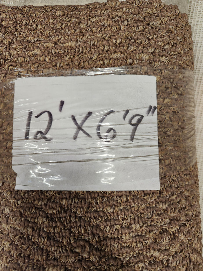 A "Carpet Remnant 12' X 6'9"" by Flooring CLEARANCE is labeled and attached to a dark brown, low pile carpet roll.