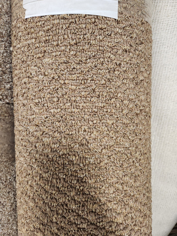 A close-up of Flooring CLEARANCE Carpet Remnant 12' X 6'9" with beige, low pile, textured looped pattern.