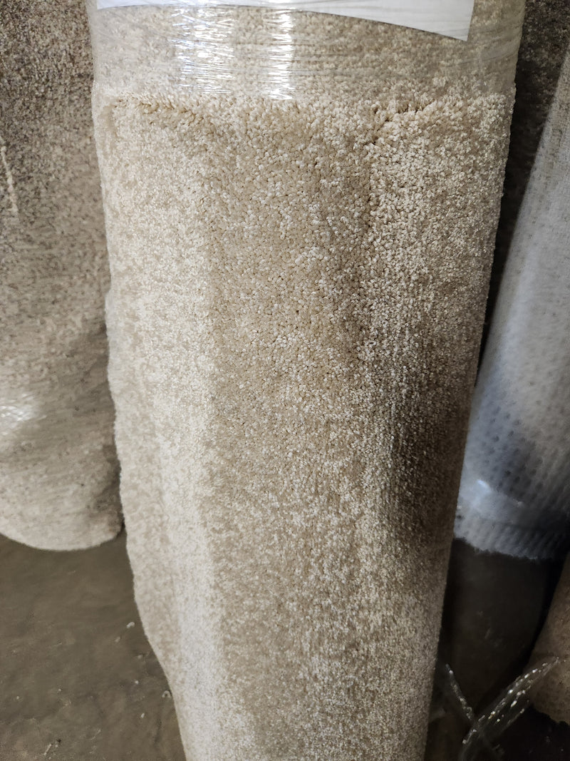 A Flooring CLEARANCE Carpet Remnant 12' X 3'6" stands upright, wrapped in clear plastic for protection.