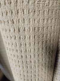 Close-up of Flooring CLEARANCE Carpet Remnant 12' X 4" shows its looped beige texture and raised vertical pattern.