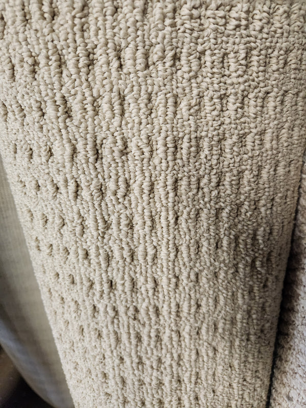 Close-up of Flooring CLEARANCE Carpet Remnant 12' X 4" shows its looped beige texture and raised vertical pattern.