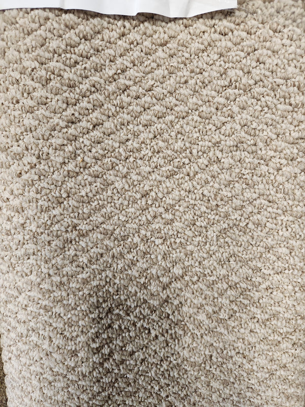 Close-up of Flooring CLEARANCE Carpet Remnant 5'8" X 6'5", beige with a hint of Medium Plie grey at the top edge.