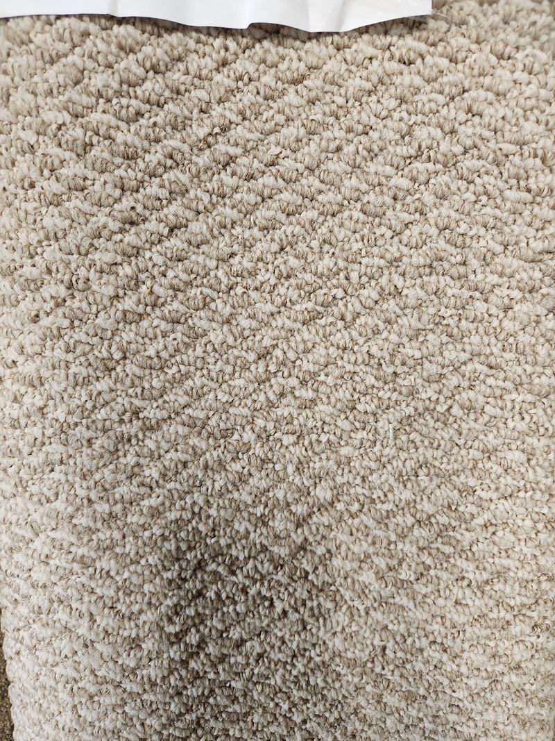 Close-up of Flooring CLEARANCE Carpet Remnant 5'8" X 6'5", beige with a hint of Medium Plie grey at the top edge.
