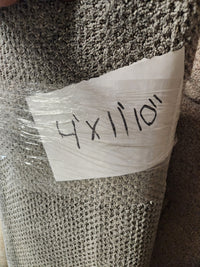 A rolled-up grey Flooring CLEARANCE Carpet Remnant 4' X 11" 10', wrapped in plastic with handwritten text.