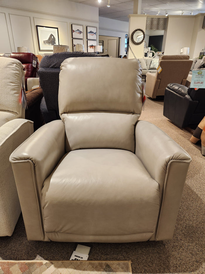 The La-Z-Boy 803 Cade Rocker Recliner in beige leather is displayed in a showroom with sofas and decor.