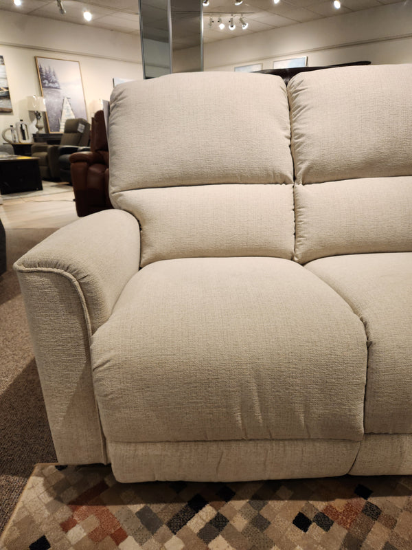 The La-Z-Boy 803 Cade Manual Reclining Loveseat sits on a patterned rug, highlighting functional luxury in a showroom.