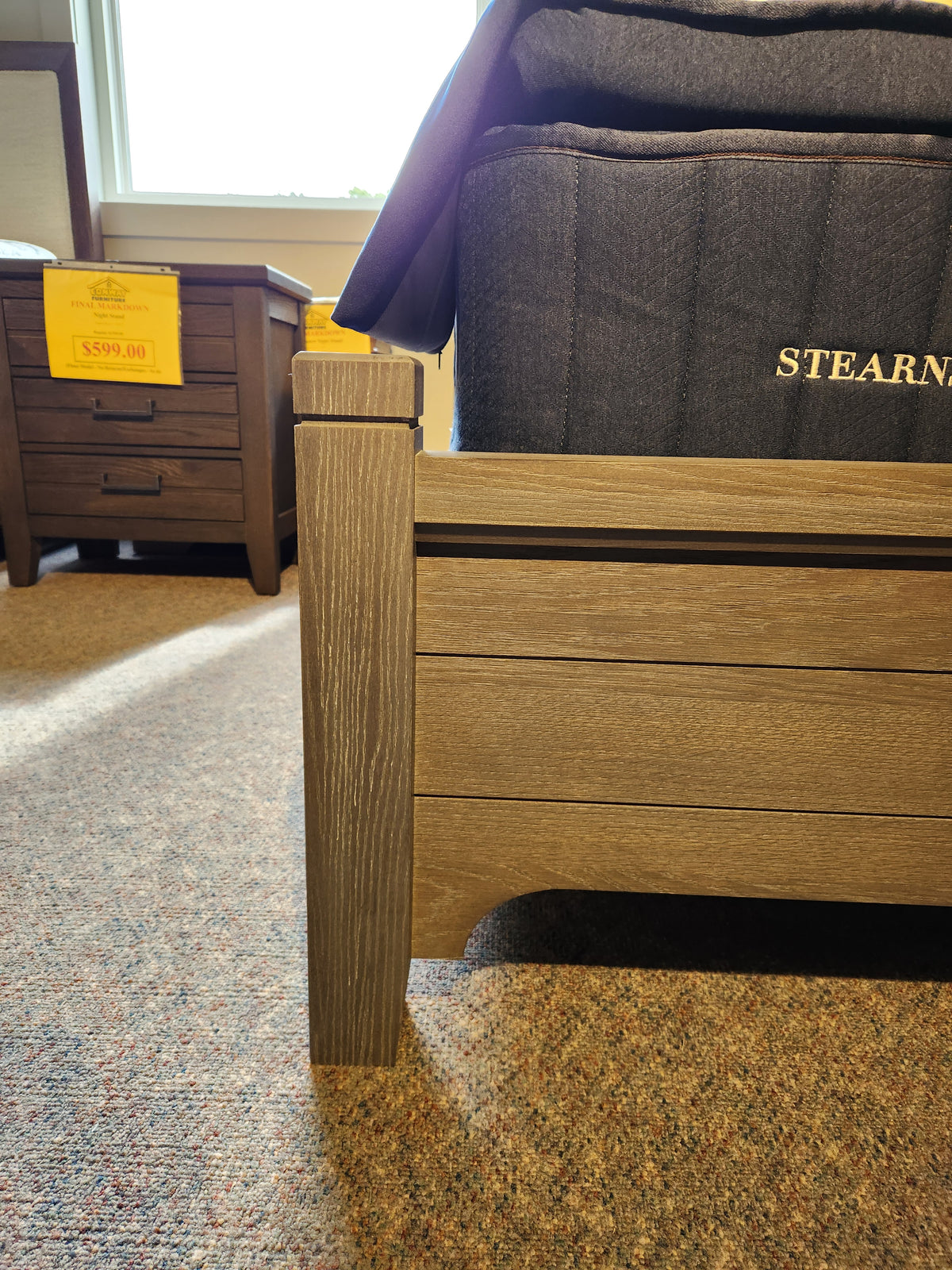 Close-up of Vaughan Bassett 740 Bungalow Arch King Bed’s wooden corner, arched headboard, bedding, and nightstand on sale.