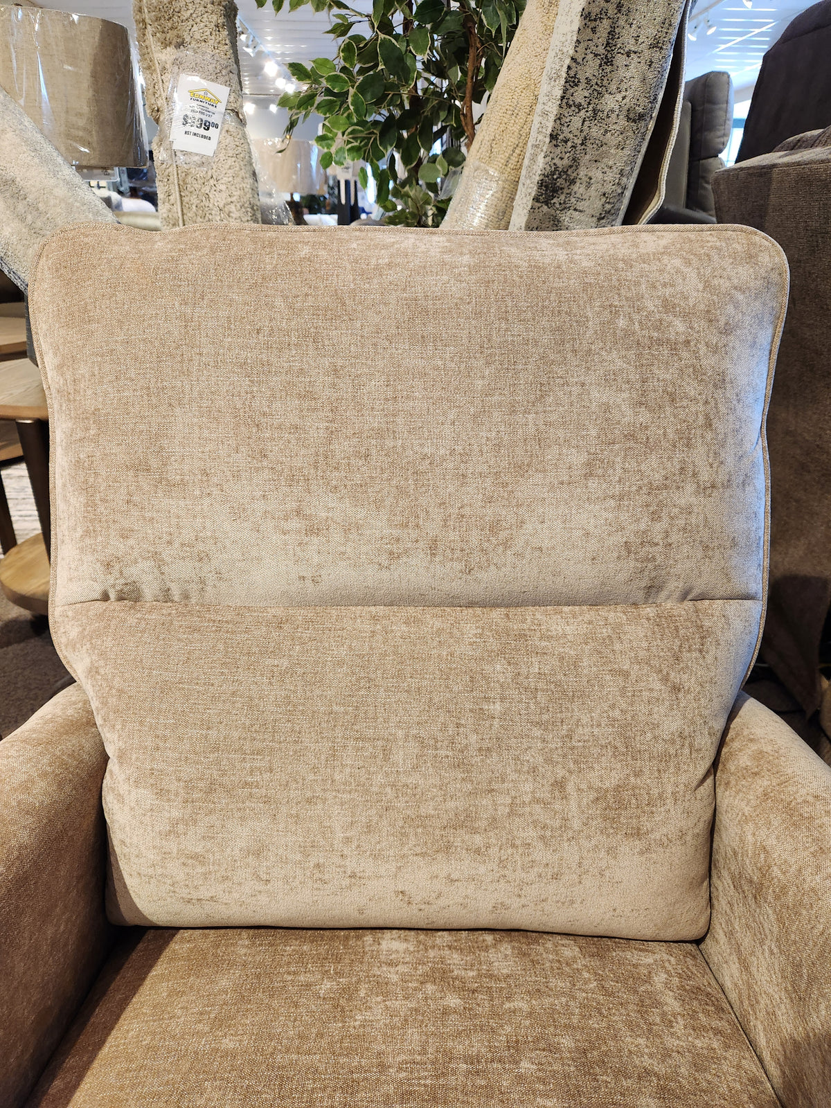 Close-up of the Palliser Pinecrest Rocker Recliner, featuring beige upholstery and plush cushions in a furniture store.