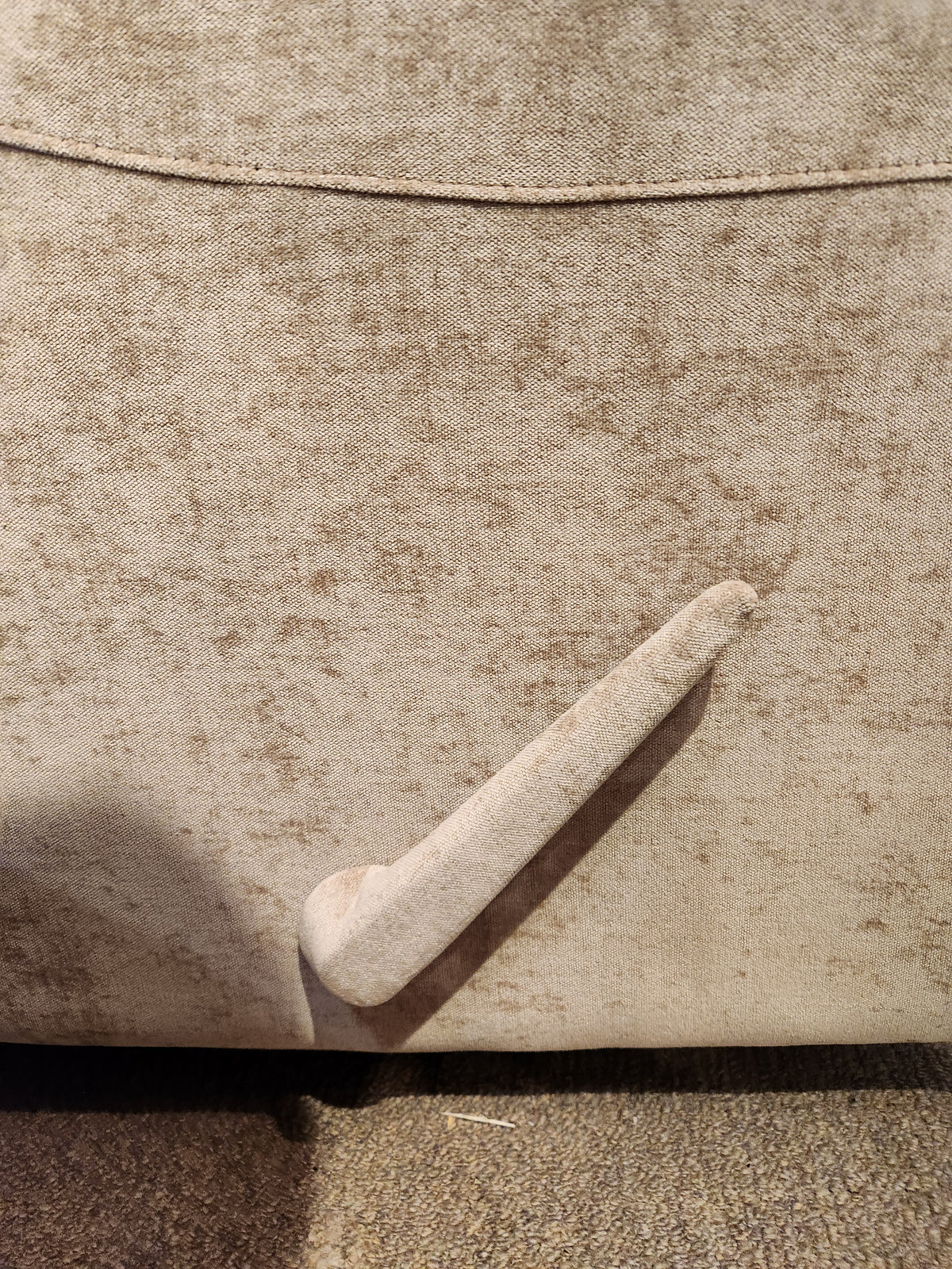 Close-up of the Palliser Pinecrest Rocker Recliner in beige, featuring rolled arms and a lowered footrest lever.
