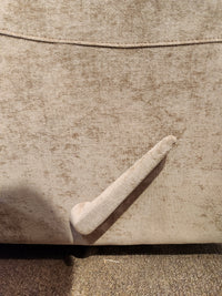 Close-up of the Palliser Pinecrest Rocker Recliner in beige, featuring rolled arms and a lowered footrest lever.