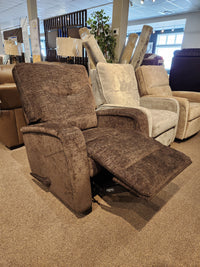 The Palliser 40034 Torrington WallHugger Recliner with padded track arms is displayed among other recliners on carpet.