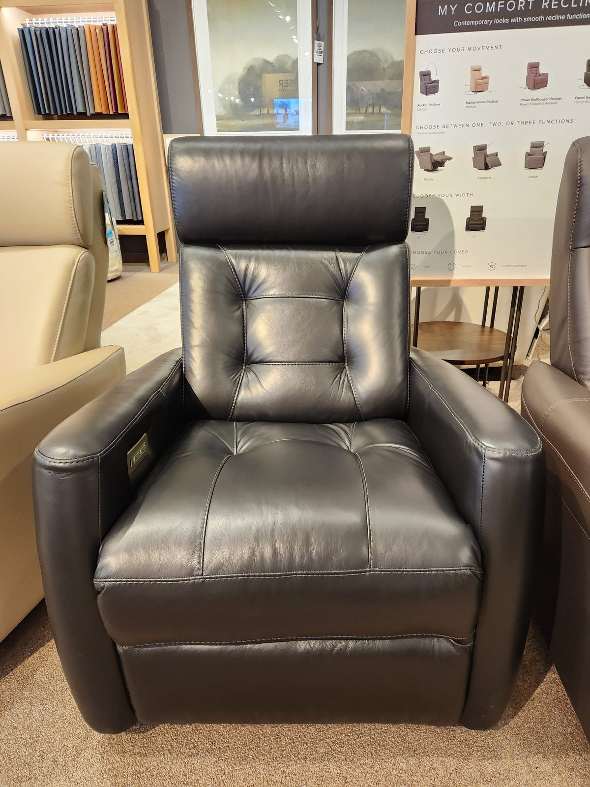 The Palliser 43411 Baltic 2 Power Swivel Glider, in black leather, features a tall back and armrests, on showroom display.