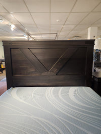 Handstone Chattanooga Queen Bed in Heritage Maple Charcoal, features a geometric headboard and light mattress.