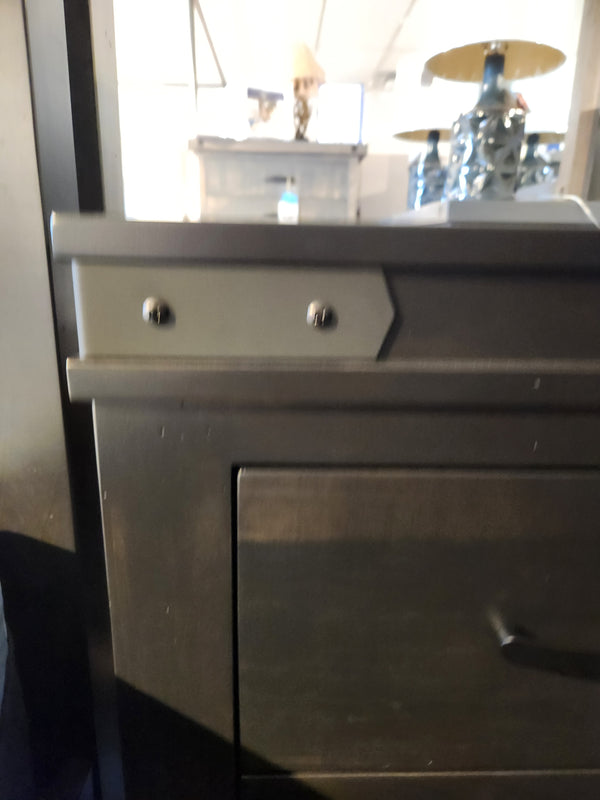 Close-up of a Handstone Chattanooga Power Nightstand with custom metal hardware, lamps, and furniture in the background.