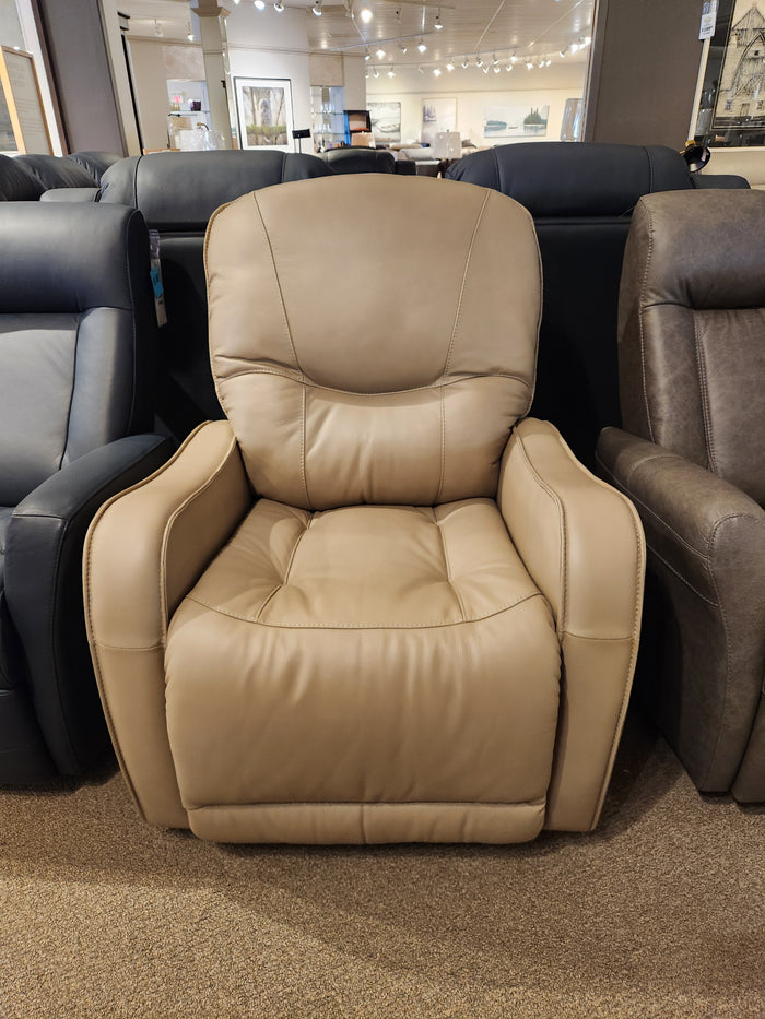 The Palliser 43012 Yates Rocker Recliner in beige real leather is shown in a showroom among other chairs.