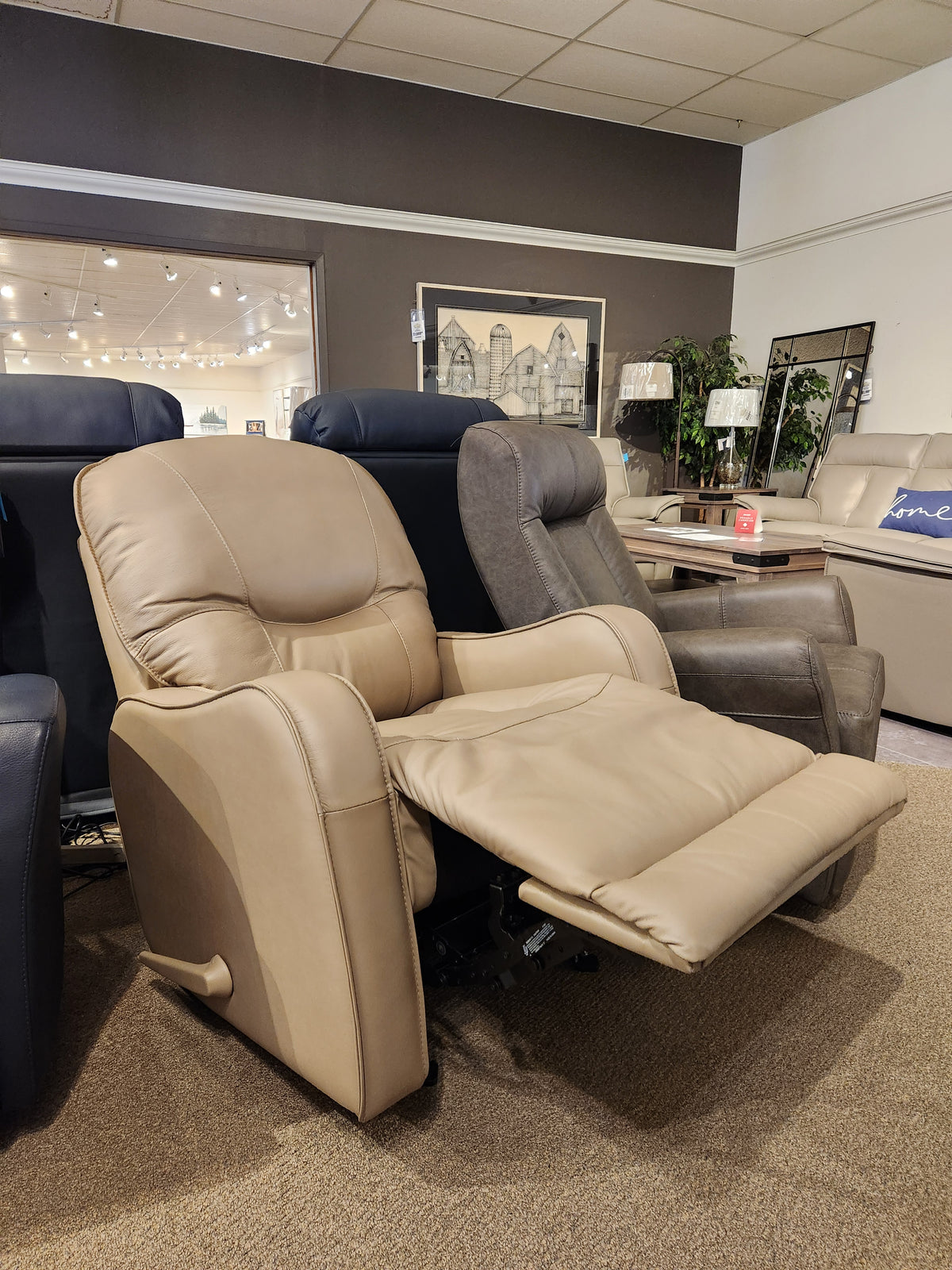 The Palliser 43012 Yates Rocker Recliner in beige real leather with high density foam and an extended footrest on display.