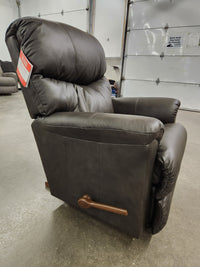 The La-Z-Boy 528 Larson All Leather Rocker Recliner in brown with a chaise seat and wooden lever, shown in showroom.