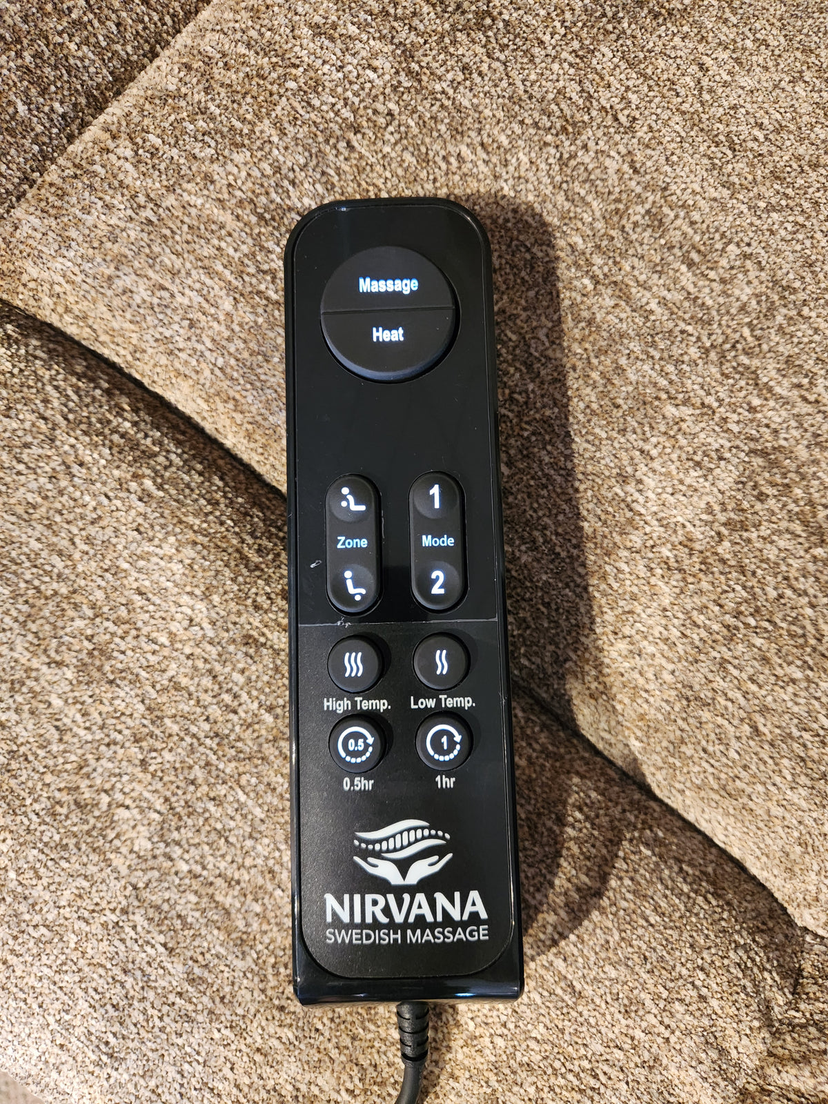 A Golden Venice PL447 Power Lift Chair remote rests on brown fabric, showing Twilight Tilt and heat features.