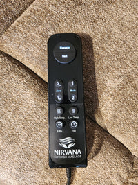 A Golden Venice PL447 Power Lift Chair remote rests on brown fabric, showing Twilight Tilt and heat features.
