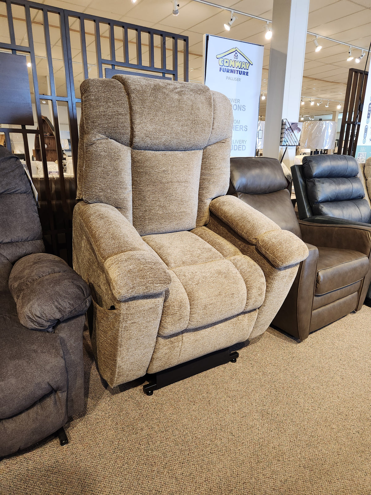 The Golden Venice PL447 Power Lift Chair in beige with Twilight Tilt, displayed among recliners in a showroom.