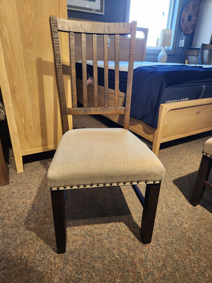 Jofran Willow Creek Slatback Chair with upholstered seat and studded trim, shown on a carpeted showroom floor.