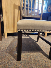 A Jofran Willow Creek 5 Piece Dining Table Set with cushioned chairs sits on carpet near pine solids.