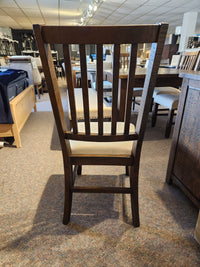 The Jofran Willow Creek 5 Piece Dining Table Set features slatted-back wooden chairs for a rustic dining space.