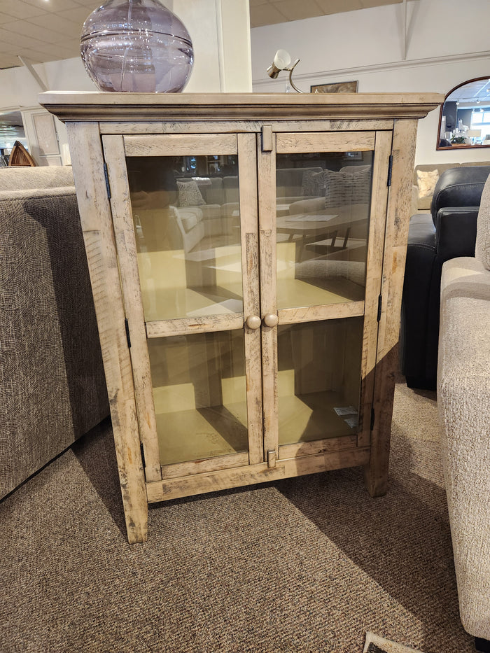 The Jofran Rustic Shores 2 Door Accent Cabinet with glass doors and two shelves sits between two sofas.