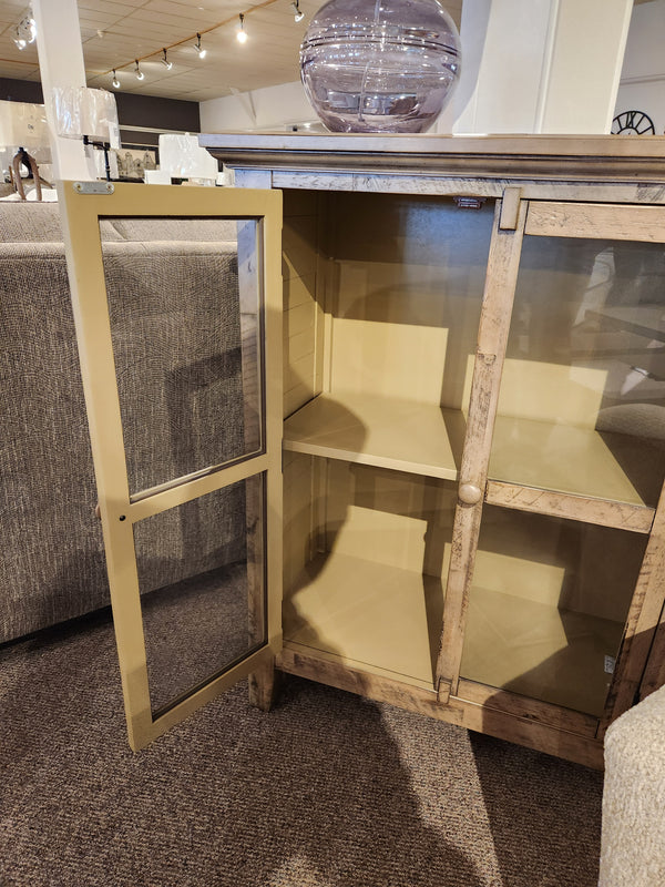 The Jofran Rustic Shores 2 Door Accent Cabinet stands open, showing two empty shelves in a showroom.
