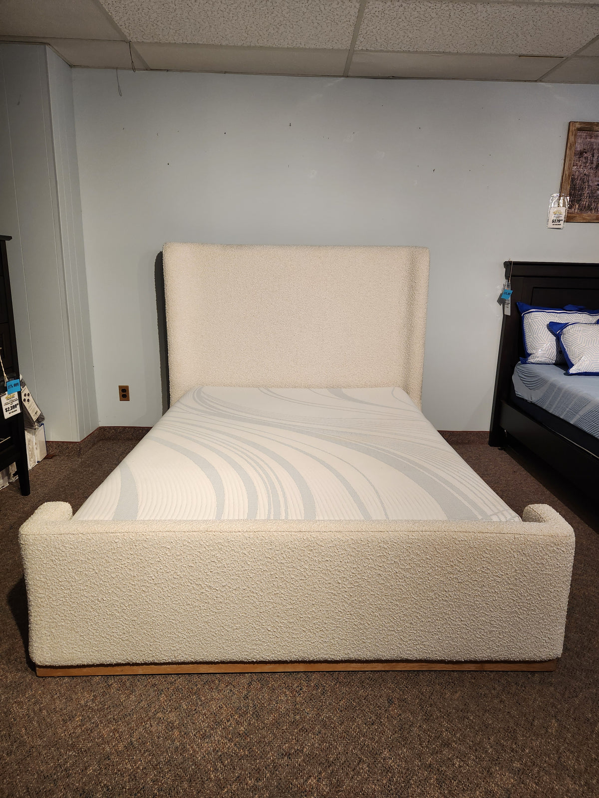 The Fashion Nala Bed features a cream boucle platform design with a high wingback headboard, shown without bedding.