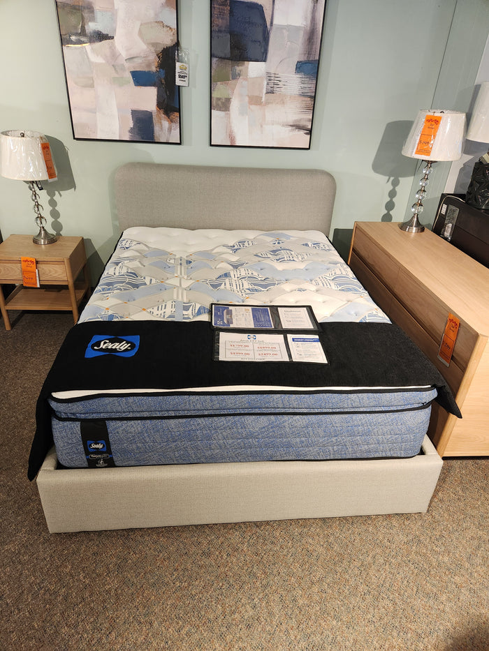 A Palliser EQ3 Nara Queen Bedframe with a modern headboard, flanked by wooden nightstands and lamps.