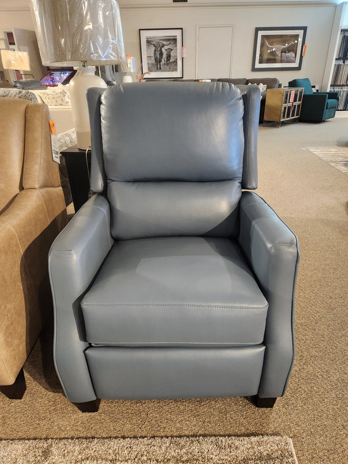 The 625 Reclining Chair by Leather Craft in blue leather, displayed among other leather furniture and framed wall art.