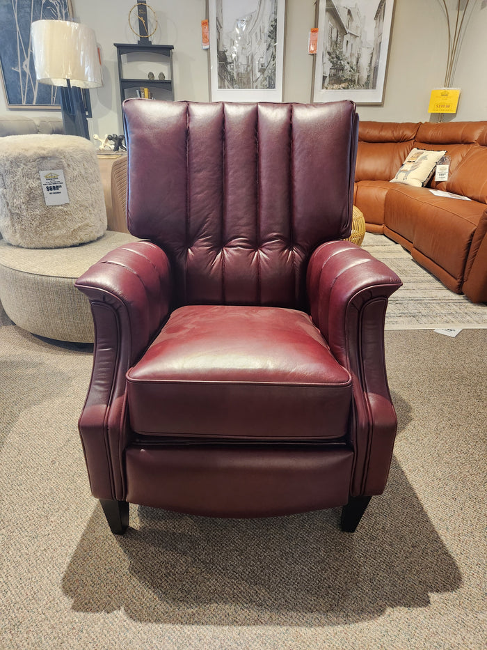 A Leather Craft 686 Reclining Chair in burgundy Canadian leather with vertical tufting is on the showroom floor.
