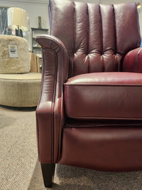 Close-up of a maroon Leather Craft 686 Reclining Chair on carpet, with another chair and lamp in the background.