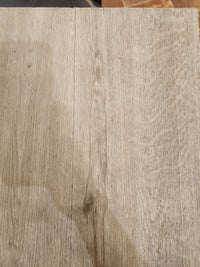Close-up of light wood tabletop with grain, resembling Beckham Brothers Posh Plank LVP - Middlesex.