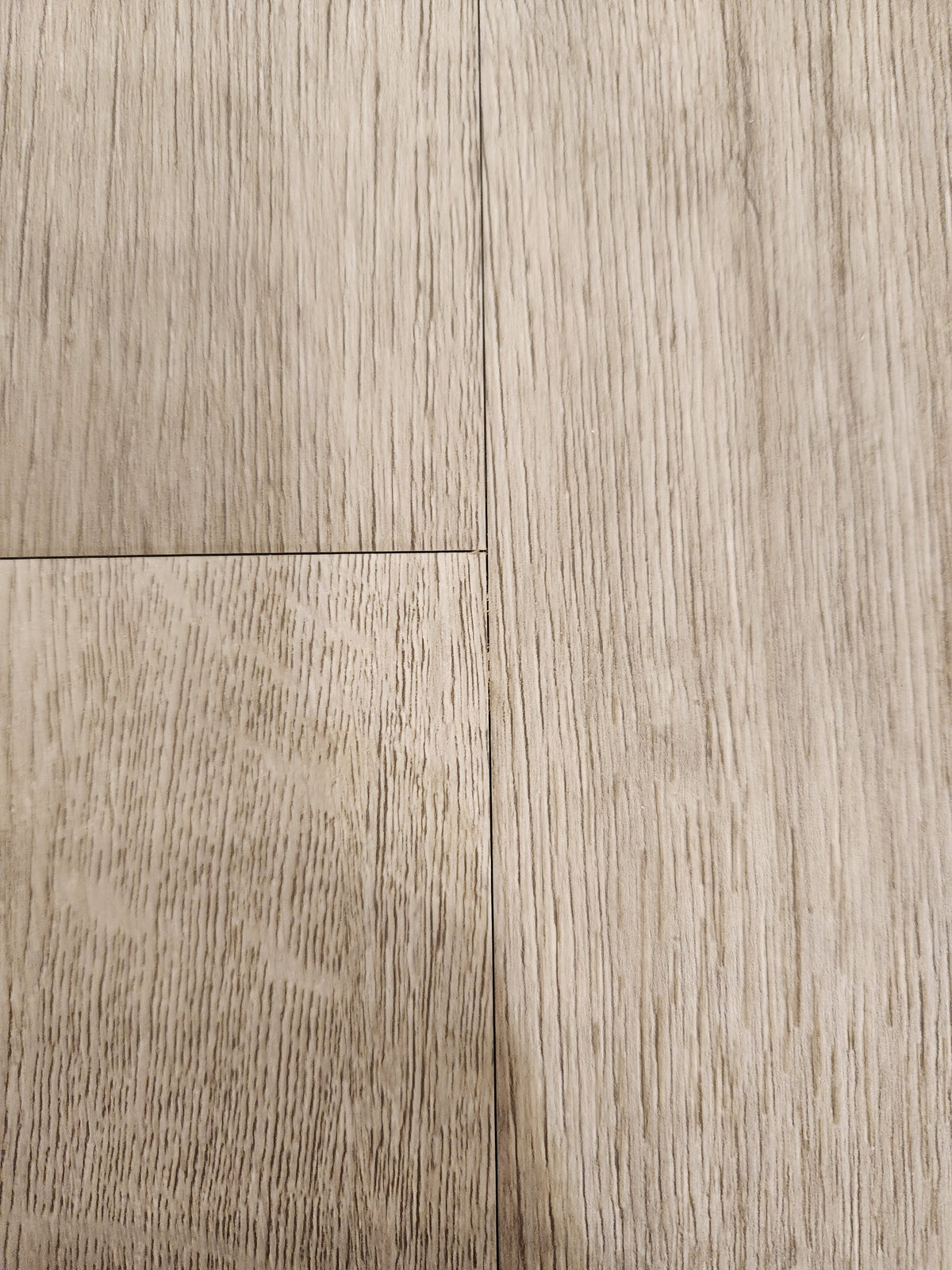 Close-up of Beckham Brothers Posh Plank LVP (Middlesex): waterproof planks with grain and slight gaps between panels.
