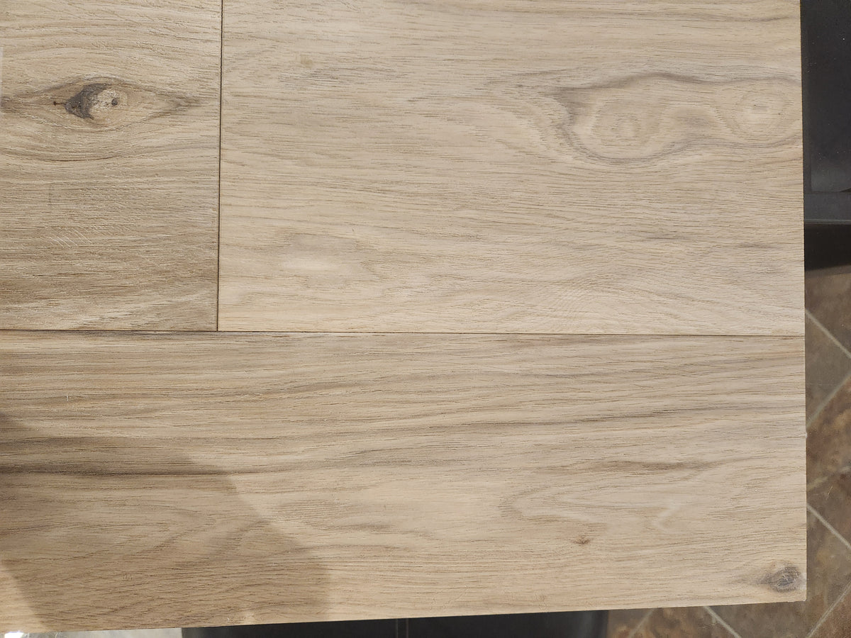 BECKHAM BROTHER'S Posh Plank Windsor features light wood-grain glue down vinyl tiles with natural knots and texture.