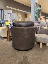 The Best Tina Swivel Chair boasts retro-mod charm and a barrel silhouette, displayed among other seating in the showroom.