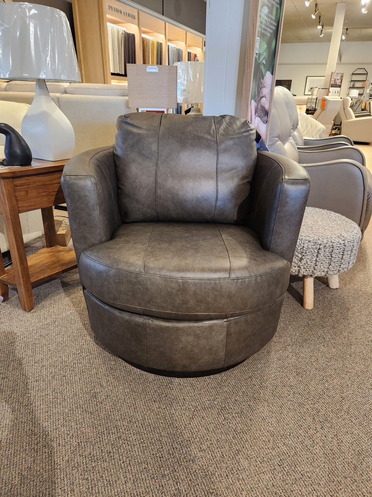 A Best Tina Swivel Chair with a barrel silhouette brings retro-mod flair to the showroom’s seating and decor display.