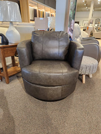 A Best Tina Swivel Chair with a barrel silhouette brings retro-mod flair to the showroom’s seating and decor display.