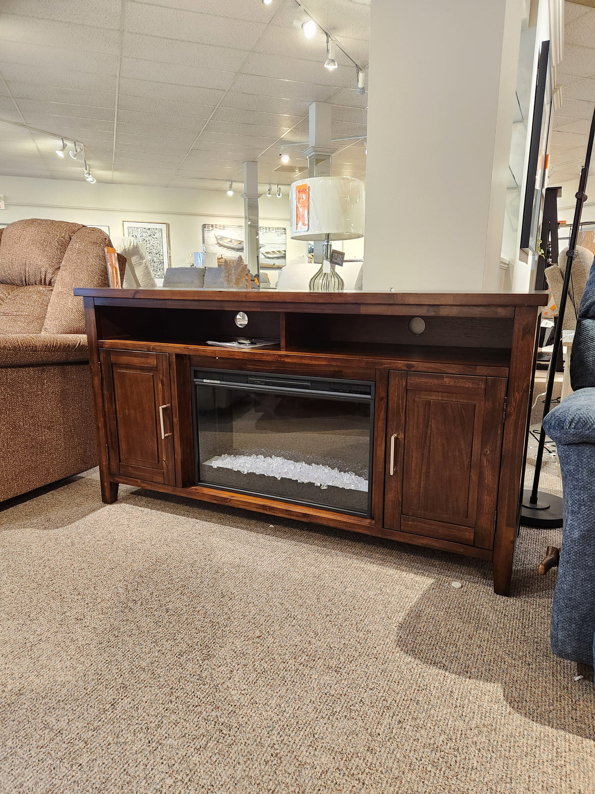Jofran Urban Icon Electric Fireplace Media Console with cabinets, media storage, and shelf on display in-store.