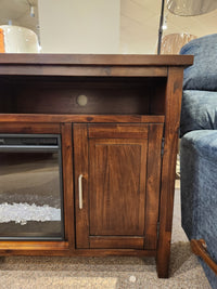 The Jofran Urban Icon Electric Fireplace Media Console features media storage, a closed door, and an open shelf.