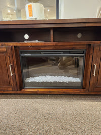 The Jofran Urban Icon Electric Fireplace Media Console features open shelves, clear stones, and a cozy ambiance for media storage.