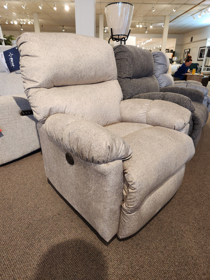 The Best 7MP84 Ellisport Power Space Saver Recliner in beige is shown in a showroom with plush upholstery.