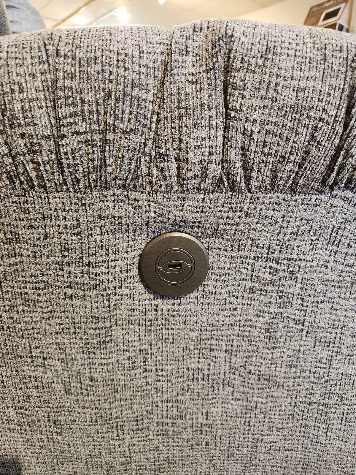 Close-up of the Best 7MP84 Ellisport Power Space Saver Recliner's gray textured back with a round button control panel.