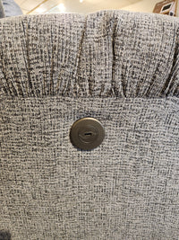 Close-up of the Best 7MP84 Ellisport Power Space Saver Recliner's gray textured back with a round button control panel.