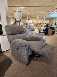 Best 7MP84 Ellisport Power Space Saver Recliner with footrest extended, shown in a showroom with other furniture.