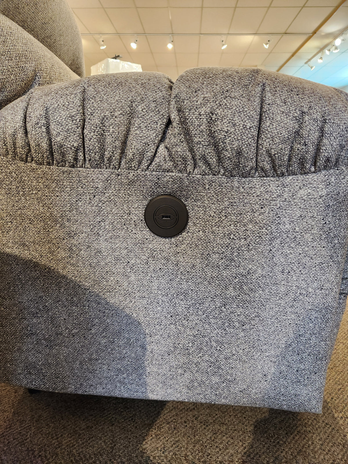 Close-up of Best 7MP84 Ellisport Power Space Saver Recliner armrest with circular button control panel.