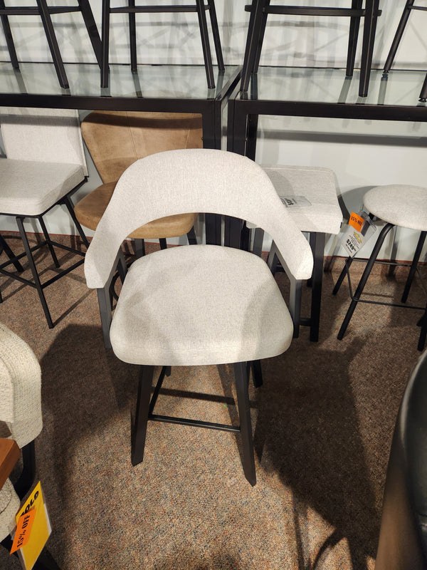 The Amisco Carmen Swivel Bar Stool features a Scandinavian design with light beige fabric and dark wooden legs.