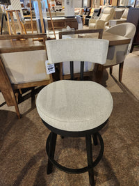 The Amisco Barry Swivel Bar Stool in light gray with a black steel base and scratch-resistant finish is on display.